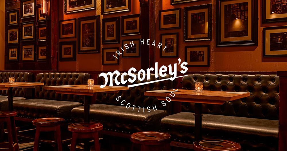McSorleys Bar Edinburgh, logo showing Irish heart, scottish soul - framed pictures on dark wall and leather seating
